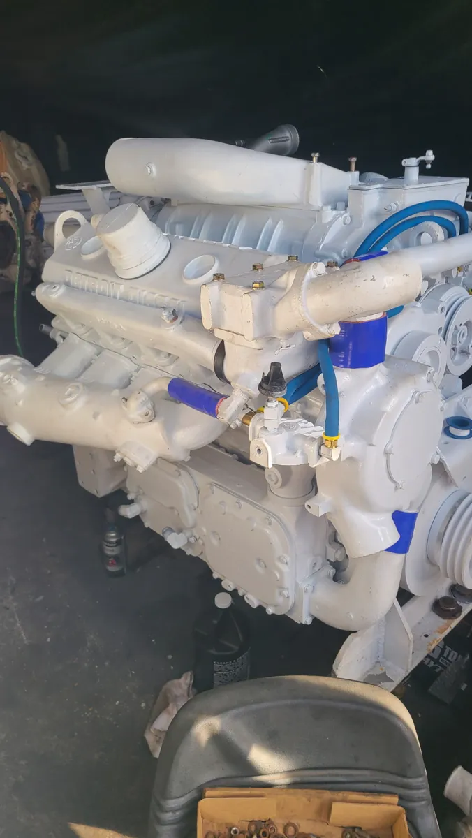 One of Gulfstream's replacement Detroit Diesel engines, painted white with new blue hoses and fittings, on stands at the shop before installation, September 2026.